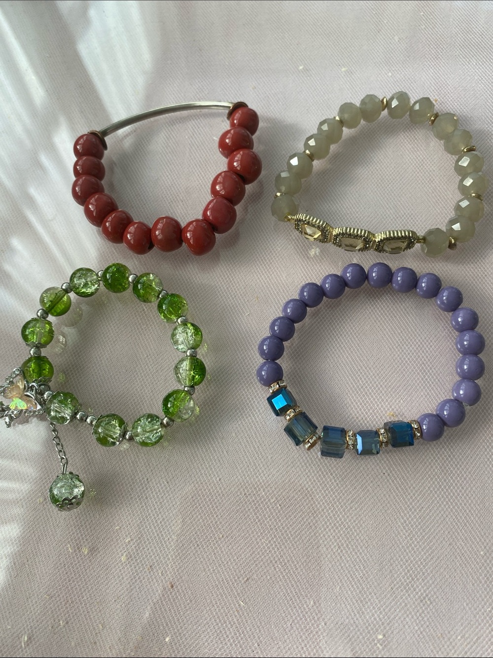 Set of Four Women's Beaded Bracelets in Red, Green, Lavender, and Gray